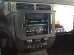 The iPad slides out the right, revealing the factory radio.
